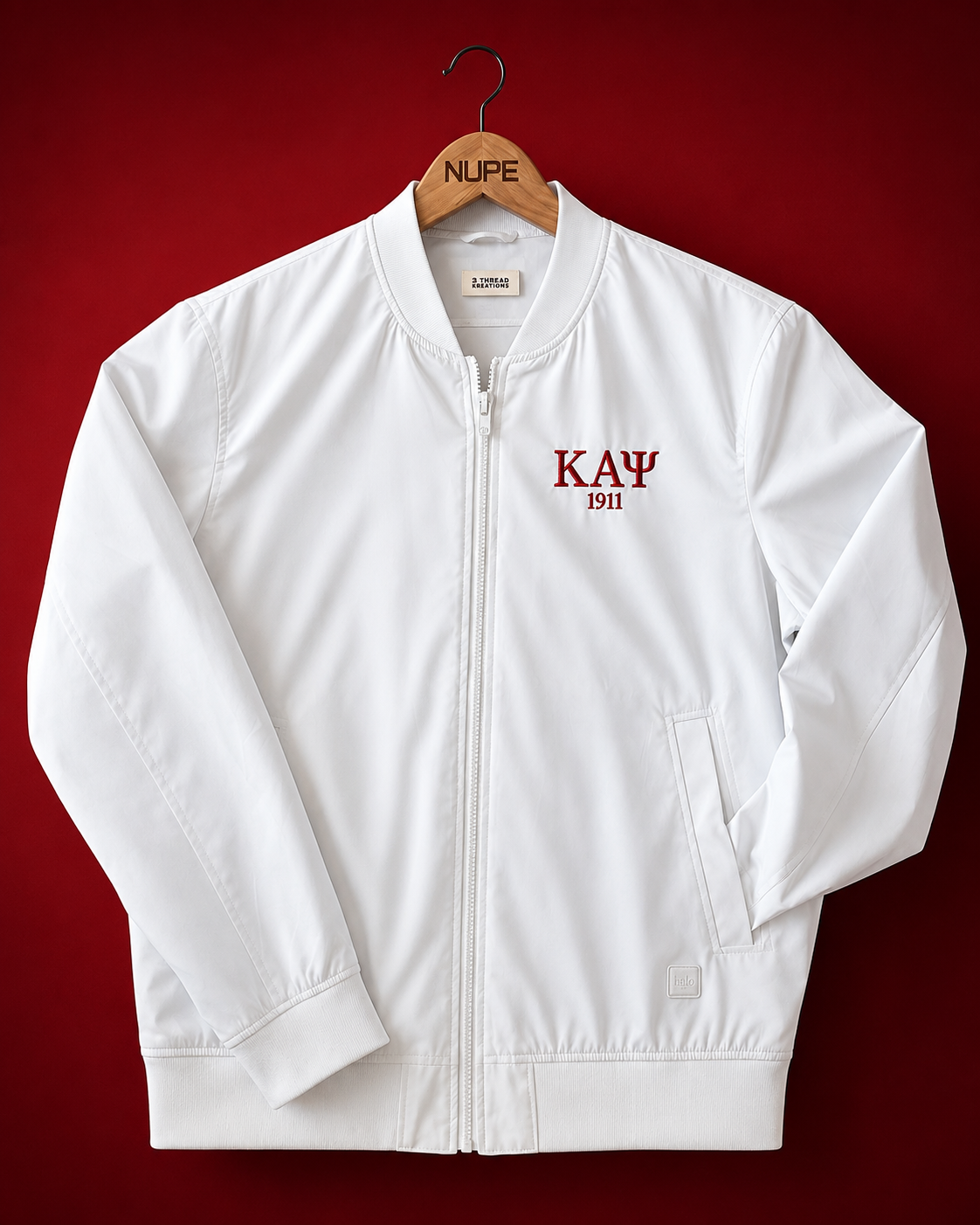 Custom embroidered white bomber jacket with crisp Greek letter abbreviation and founding year in crimson thread on left chest, full-length center zip, and ribbed finishing.