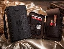 Dark brown leather folding cigar travel case open to show cigar sleeves, cutter, lighter and pen