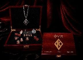 Rosewood gift box open to show a black velvet interior with lapel pins and cufflinks, Phi Nu Pi on the lid
