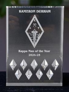 Clear crystal award engraved Kappa Man of the Year with a sword and crest motif above a row of diamonds